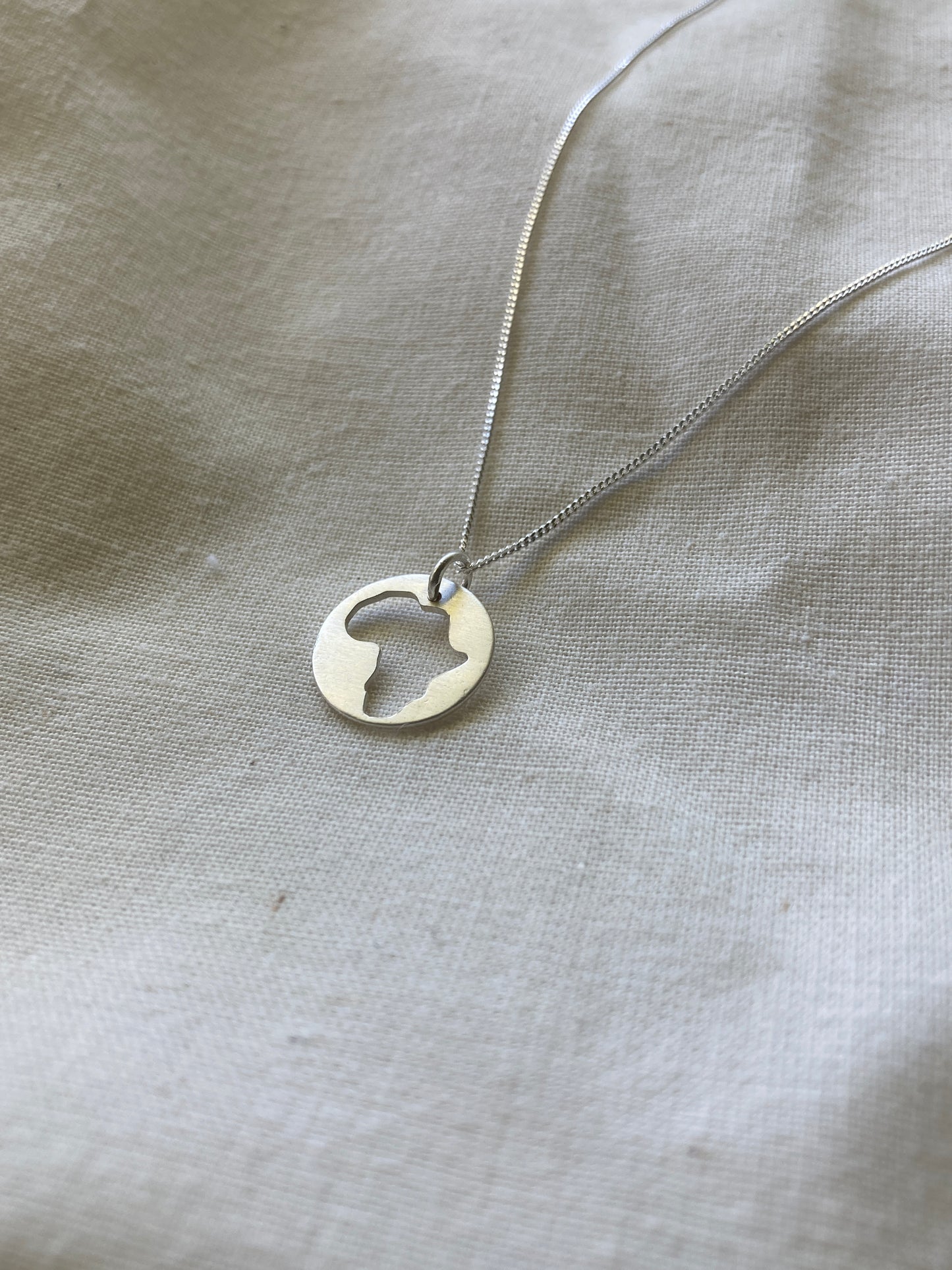 Sterling Silver Disc with Africa cut-out on Sterling Silver Chain