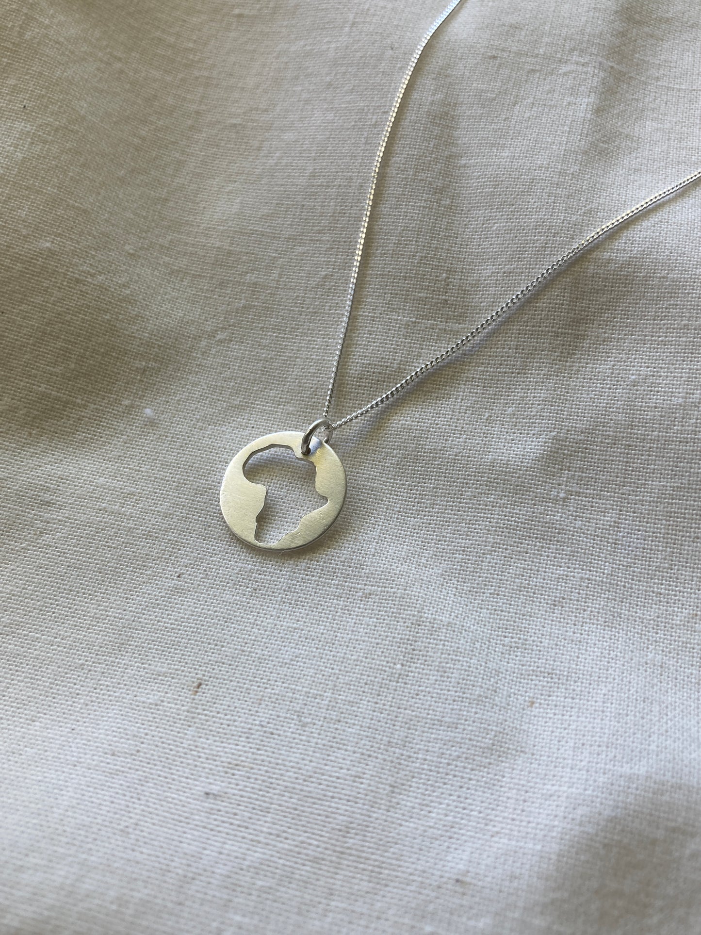 Sterling Silver Disc Pendant with cut-out Africa