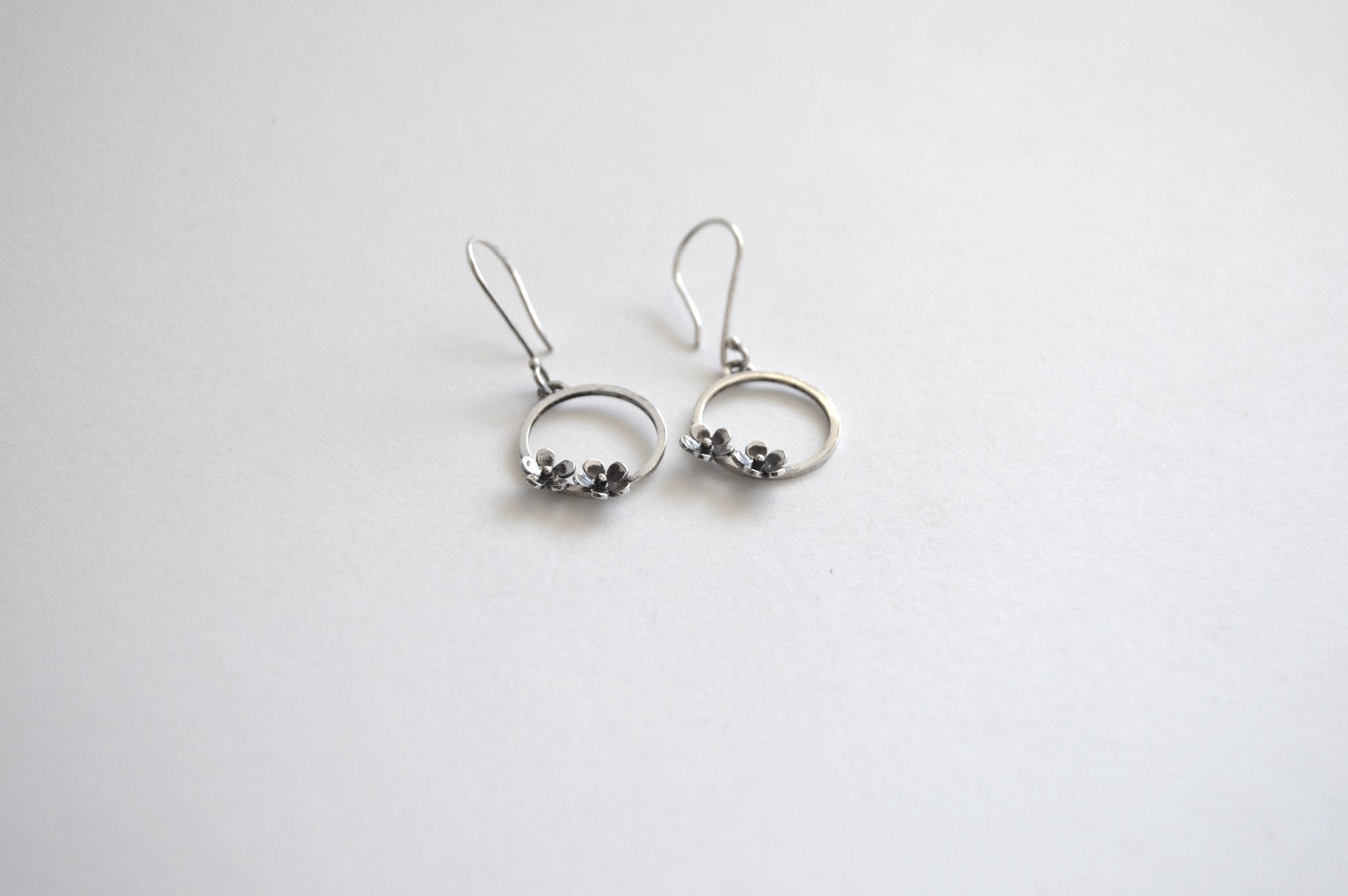 Sterling Silver Circle with two small Blooming Flowers on Silver Hook Earrings