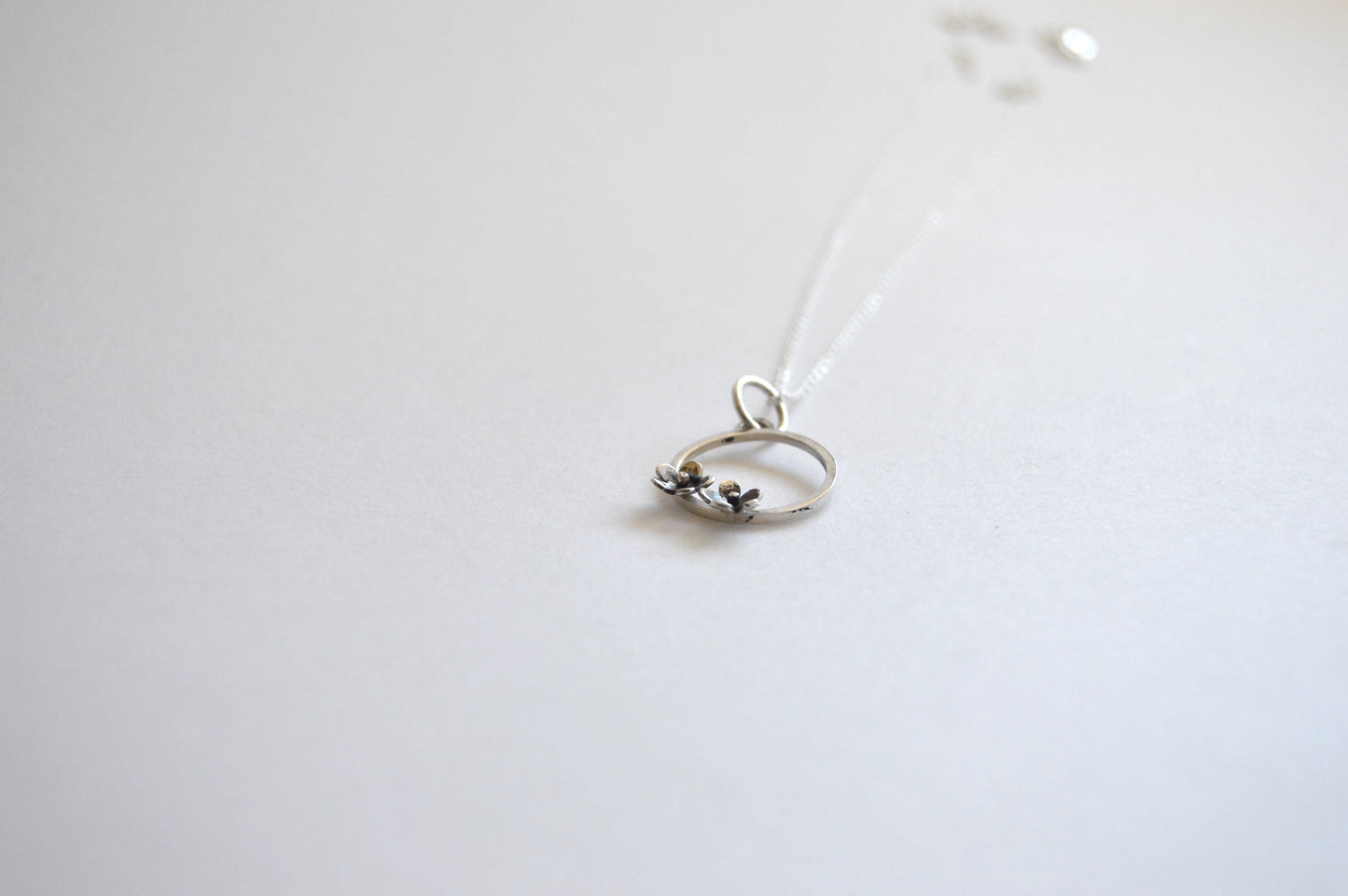 Sterling Silver Circle with two small Blooming Flowers Pendant on Silver Chain