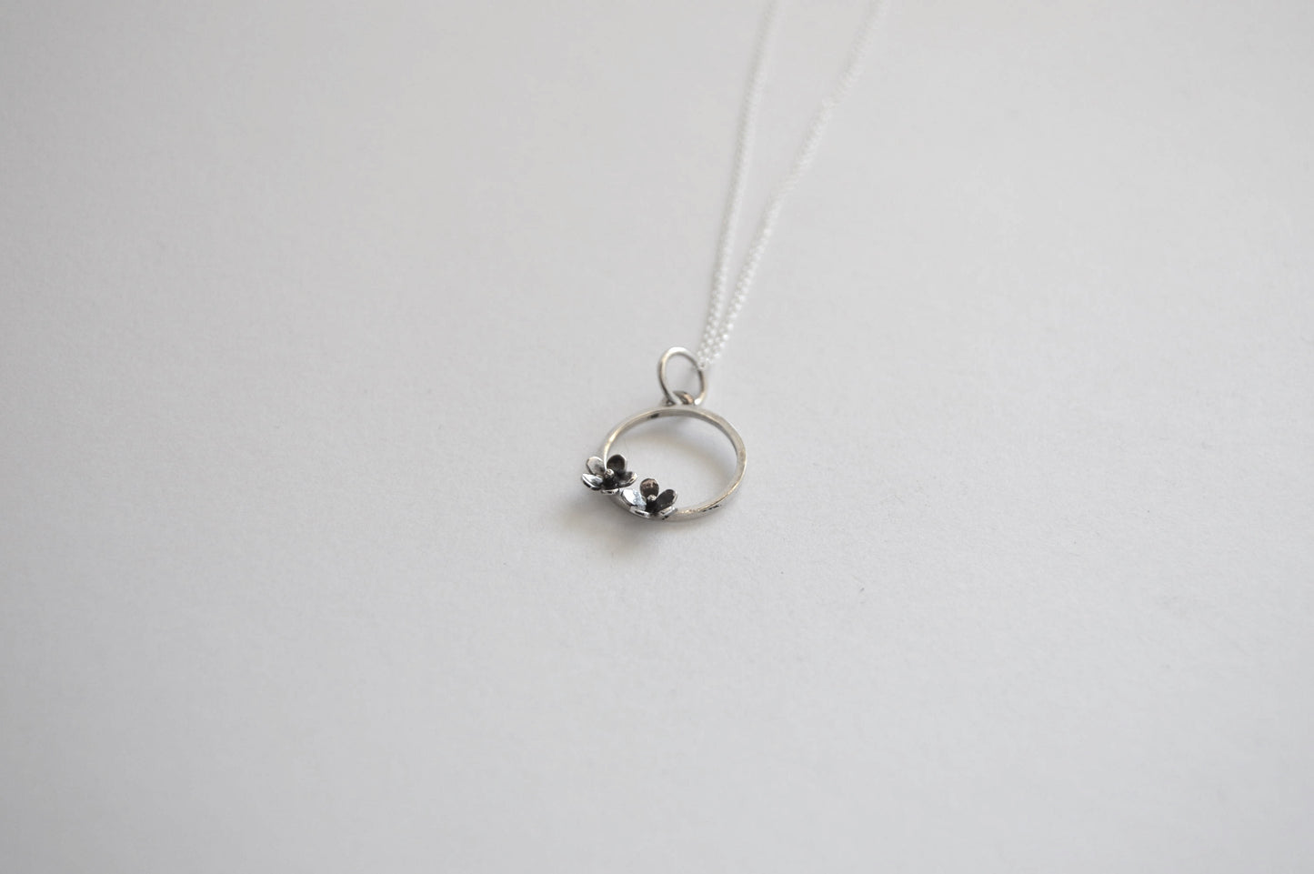 Sterling Silver Circle with two small Blooming Flowers Pendant on Silver Chain