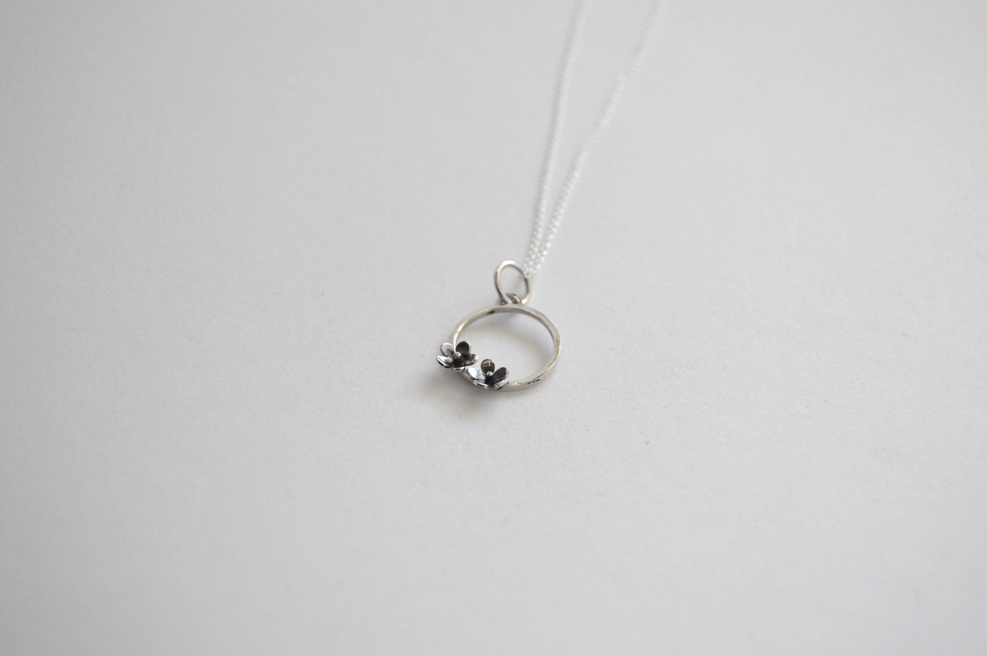 Sterling Silver Circle with two small Blooming Flowers Pendant on Silver Chain