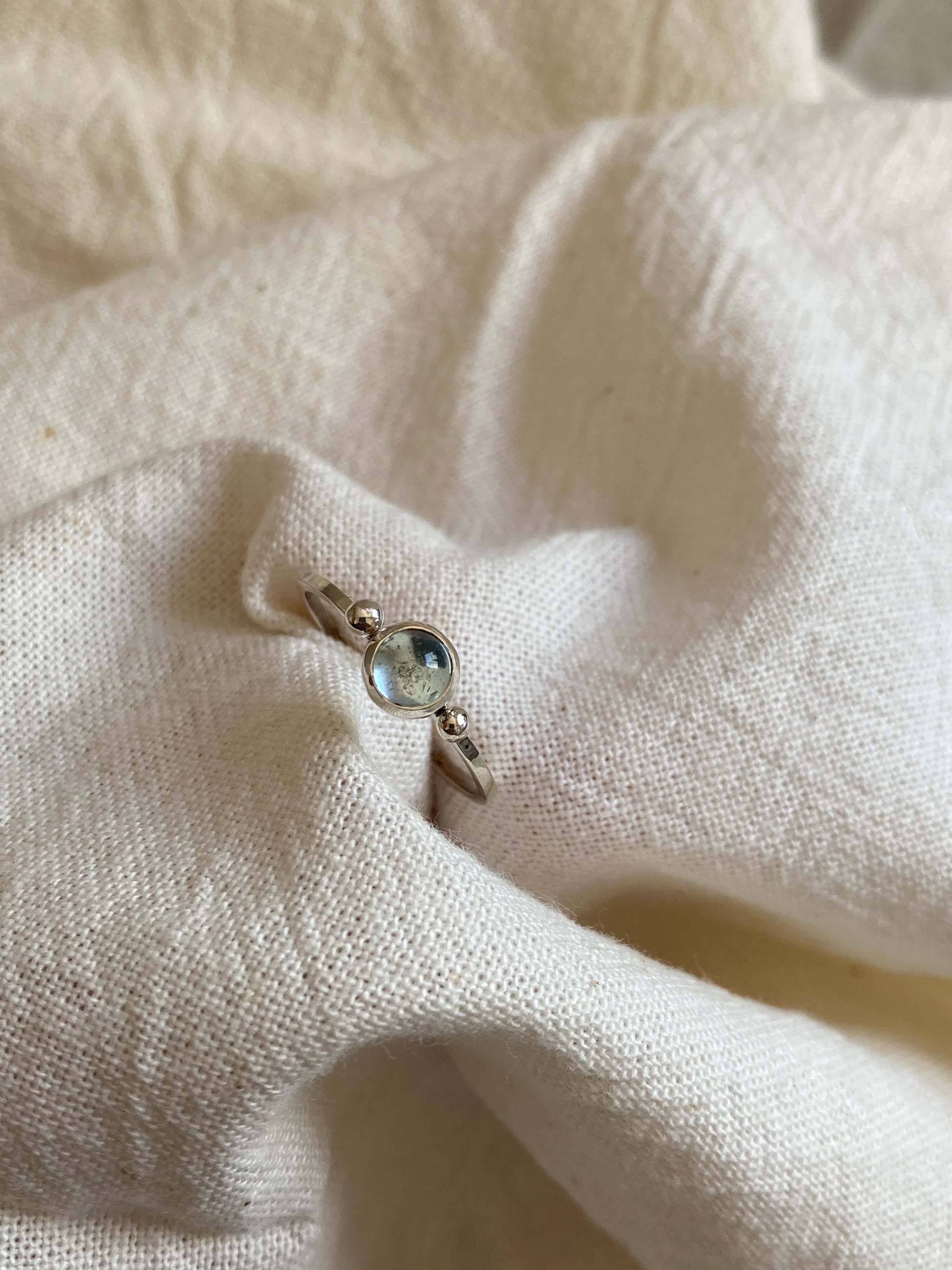 Sterling Silver Ring with two balls on either side of a Sky Blue Topaz Cabochon Stone