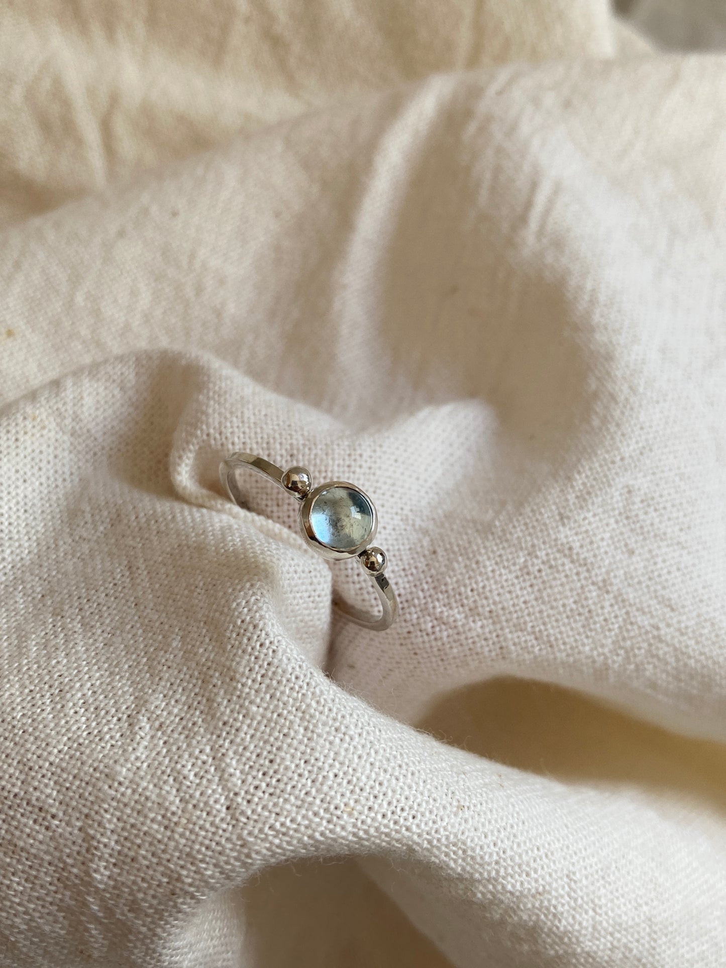 Sterling Silver Ring with two balls on either side of a Sky Blue Topaz Cabochon Stone