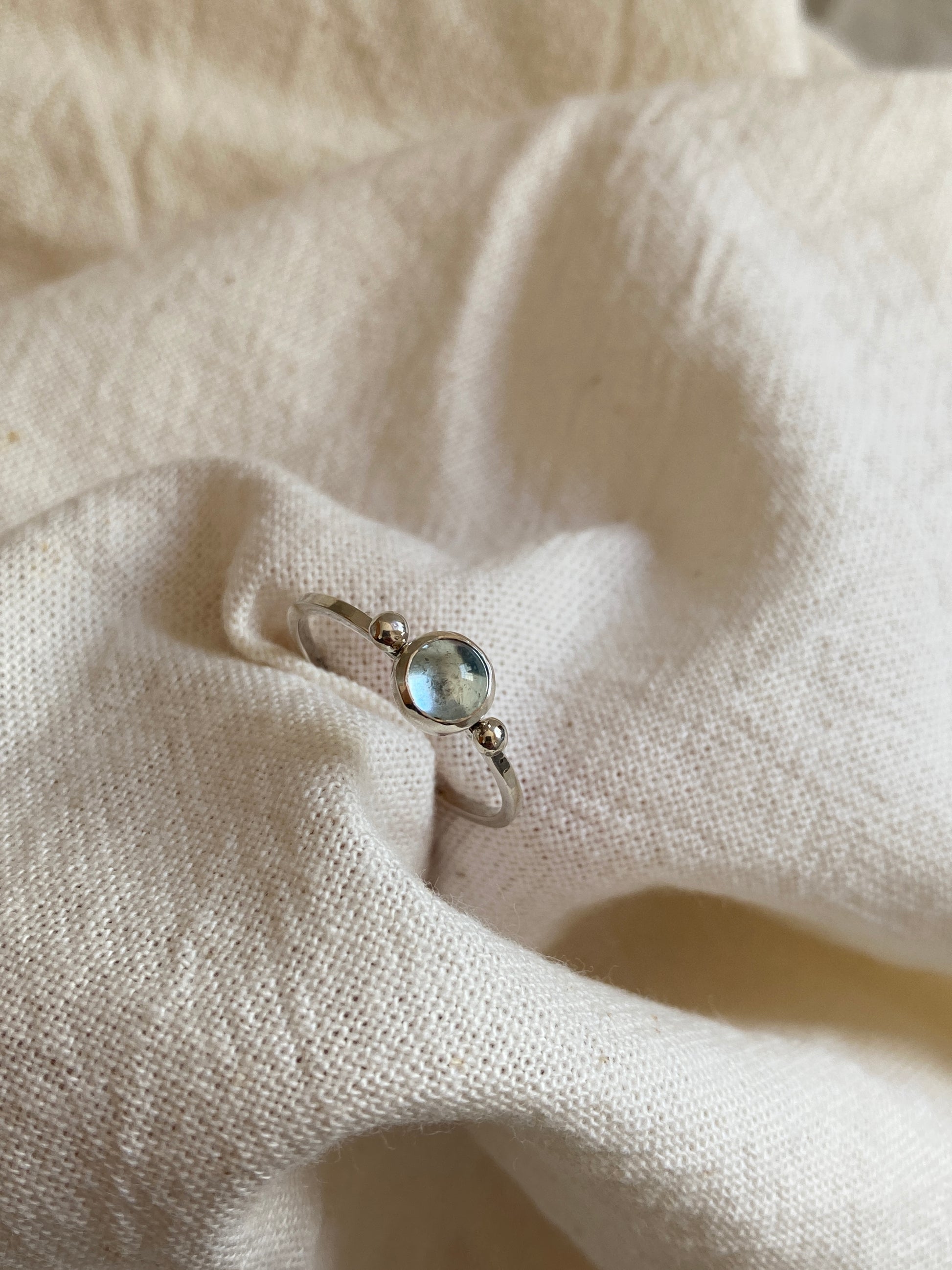 Sterling Silver Ring with two balls on either side of a Sky Blue Topaz Cabochon Stone