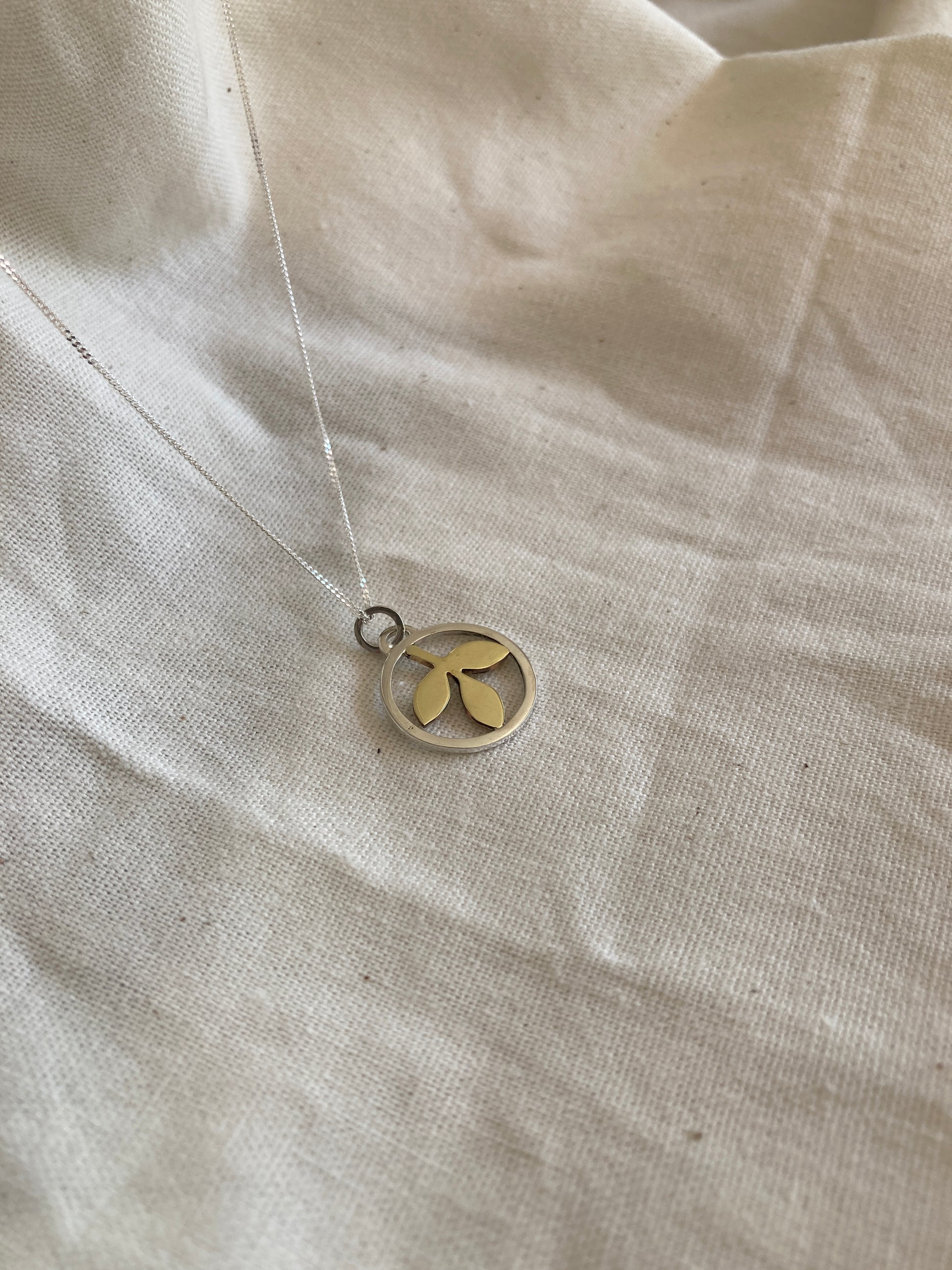 Sterling Silver Circle With Brass Leaves Pendant on Sterling Silver Chain