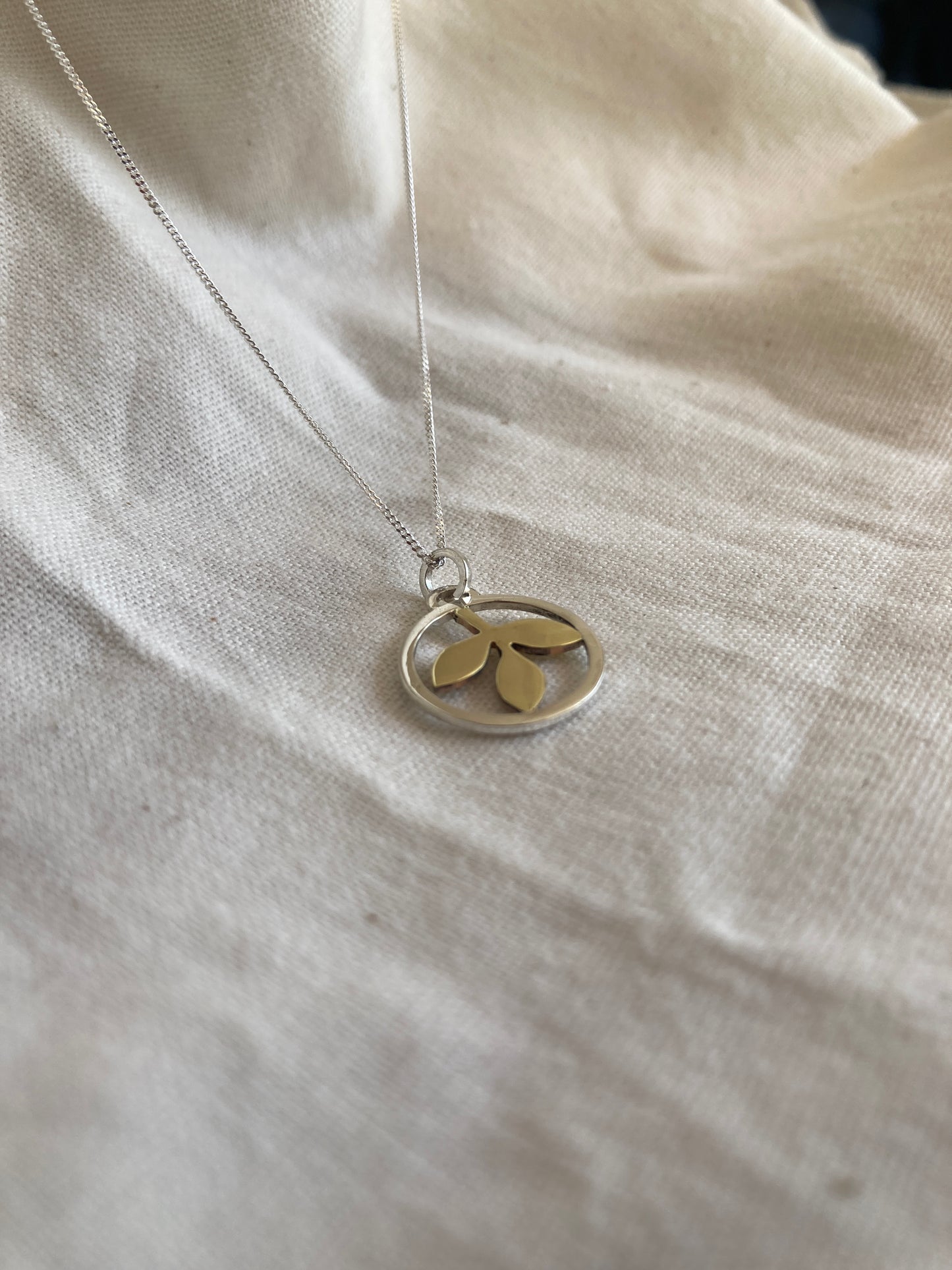 Sterling Silver Circle With Brass Leaves Pendant on Sterling Silver Chain