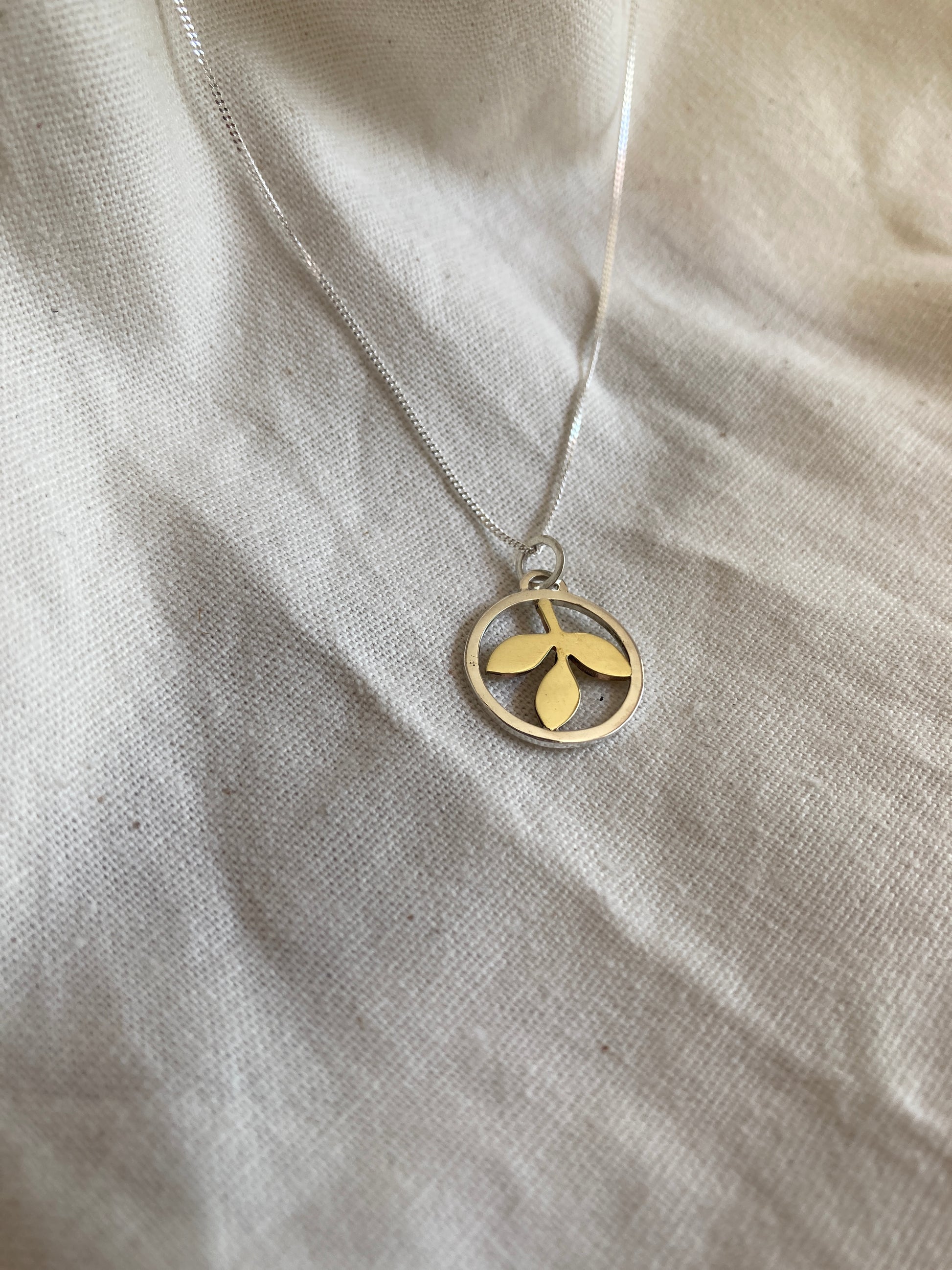 Sterling Silver Circle With Brass Leaves Pendant on Sterling Silver Chain