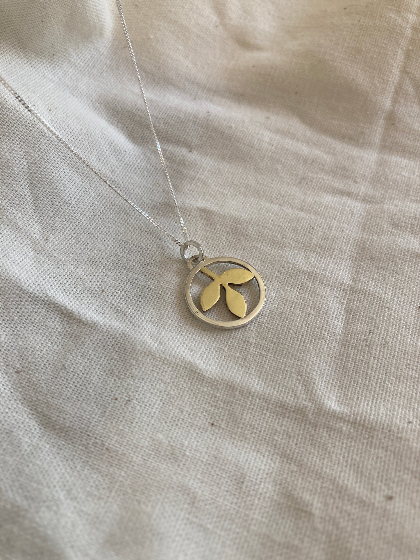 Sterling Silver Circle With Brass Leaves Pendant on Sterling Silver Chain