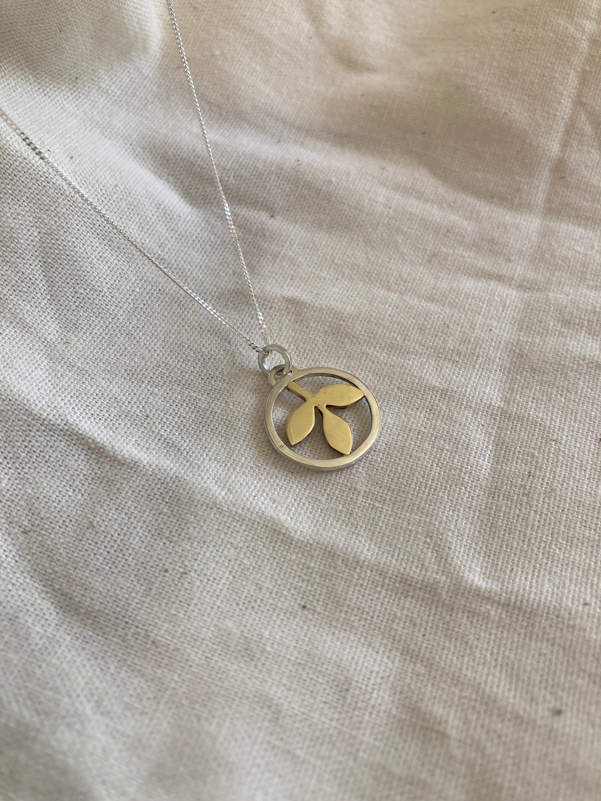 Sterling Silver Circle With Brass Leaves Pendant on Sterling Silver Chain