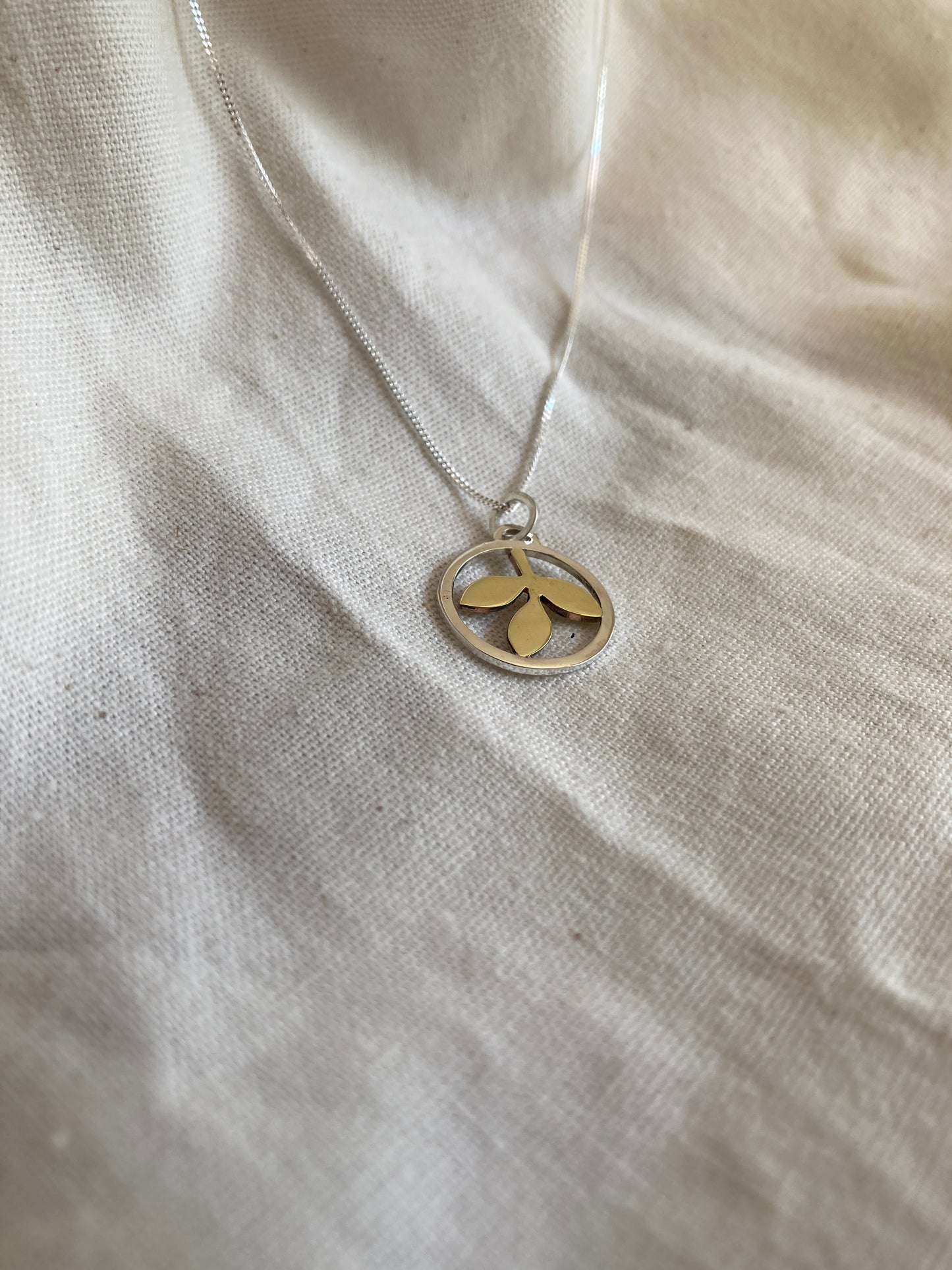 Sterling Silver Circle With Brass Leaves Pendant on Sterling Silver Chain