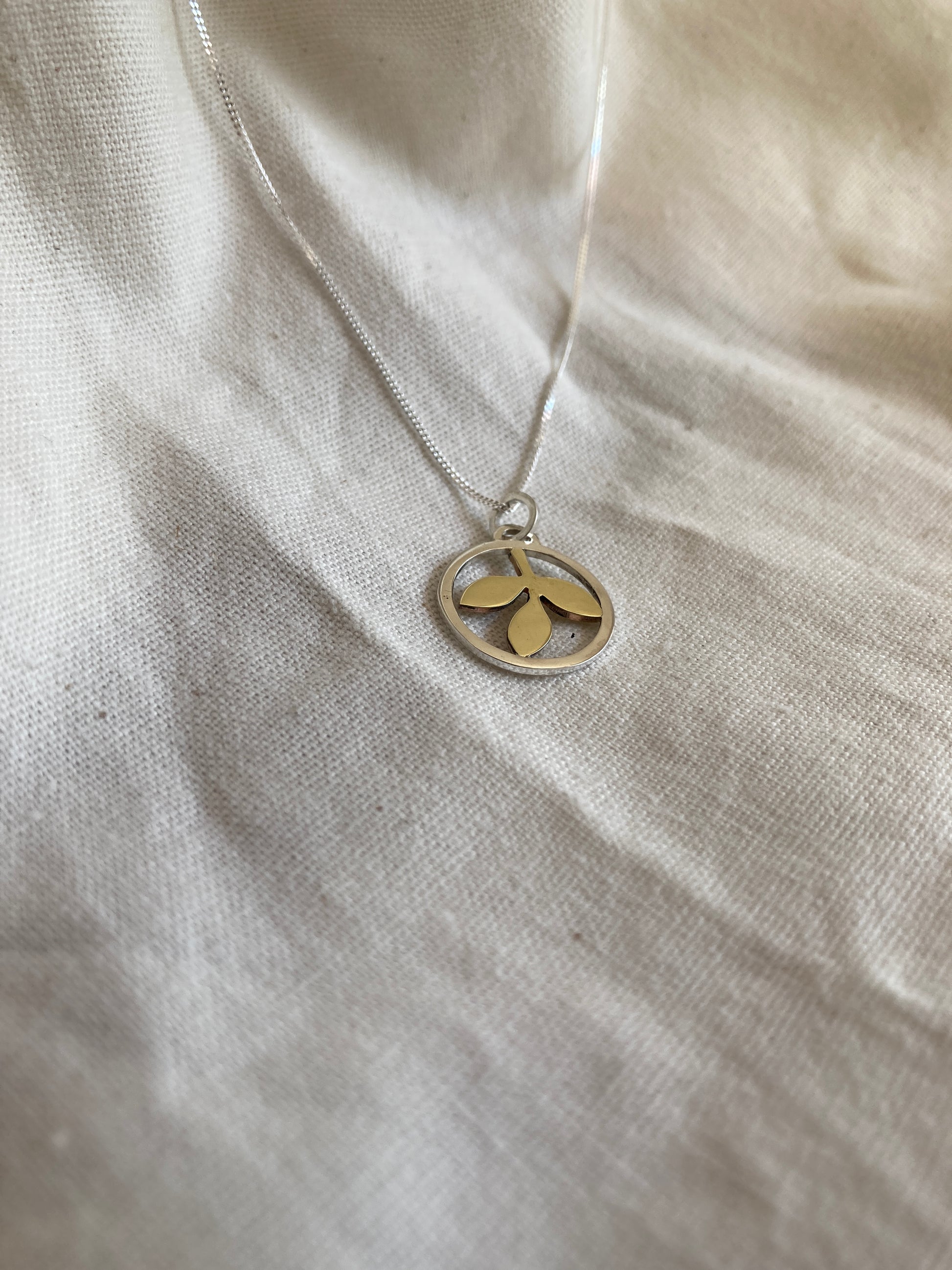 Sterling Silver Circle With Brass Leaves Pendant on Sterling Silver Chain