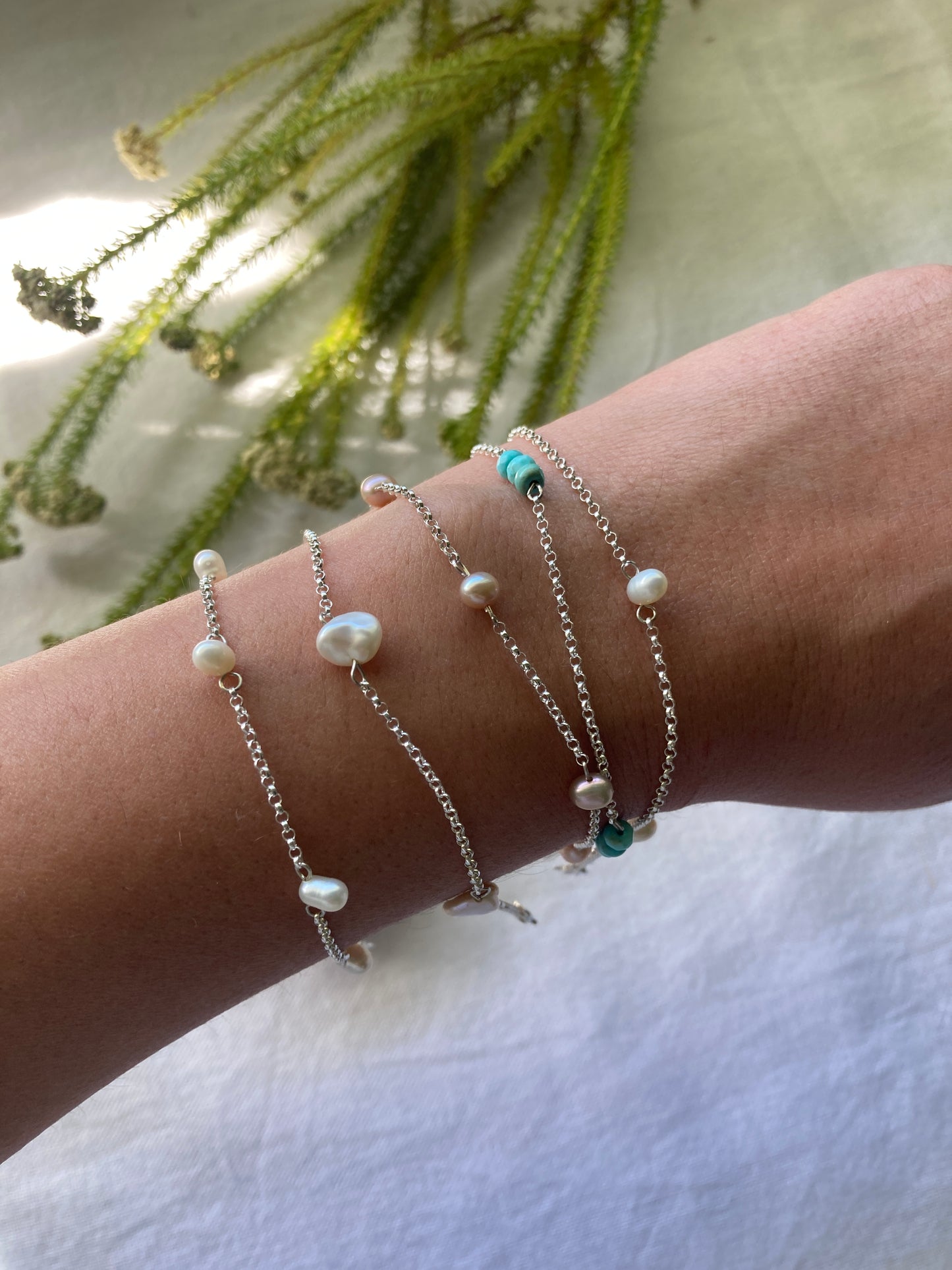 Collection of Sterling Silver Chain Scattered Bracelets on arm