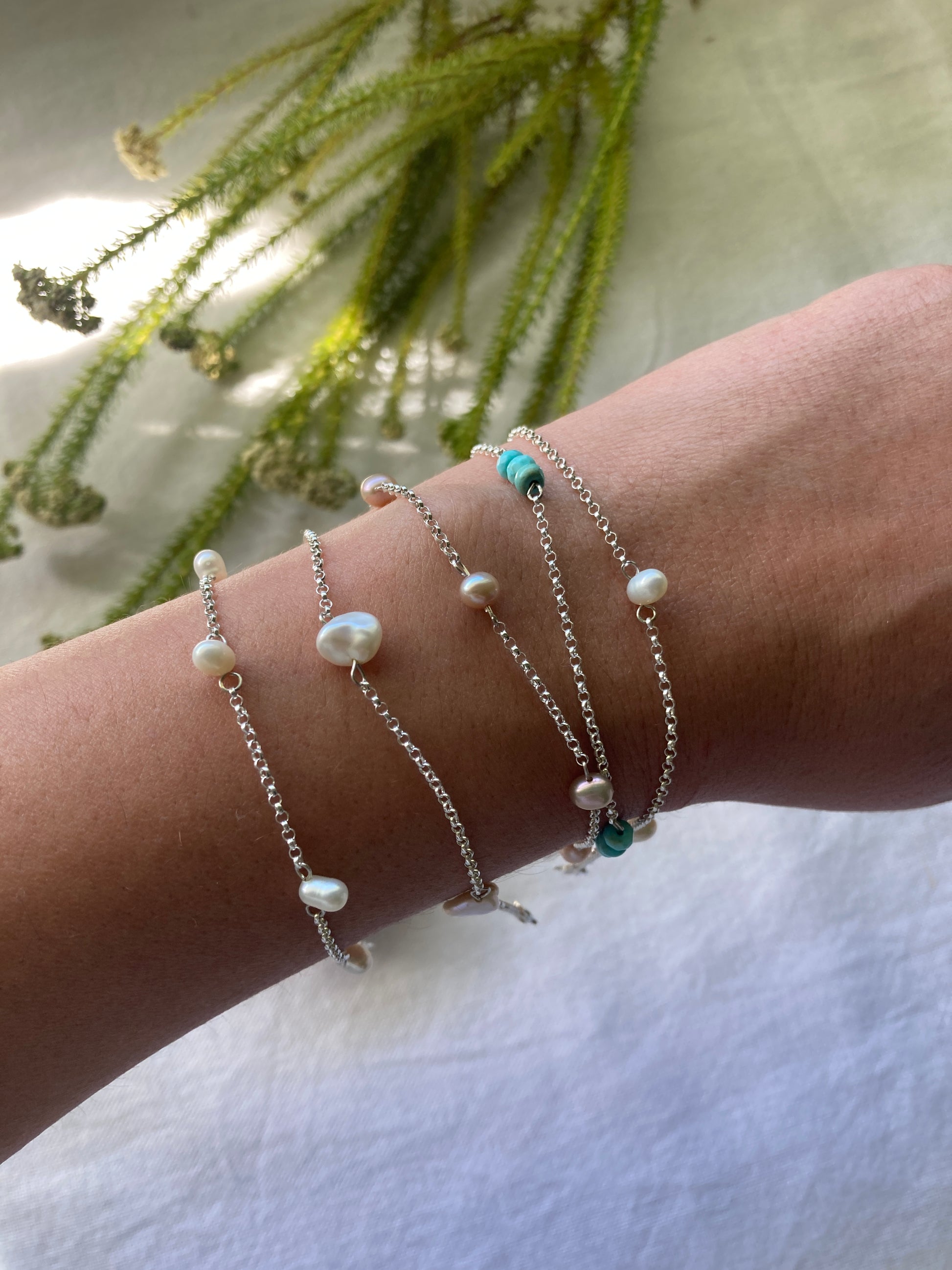 Collection of Sterling Silver Chain Scattered Bracelets on arm