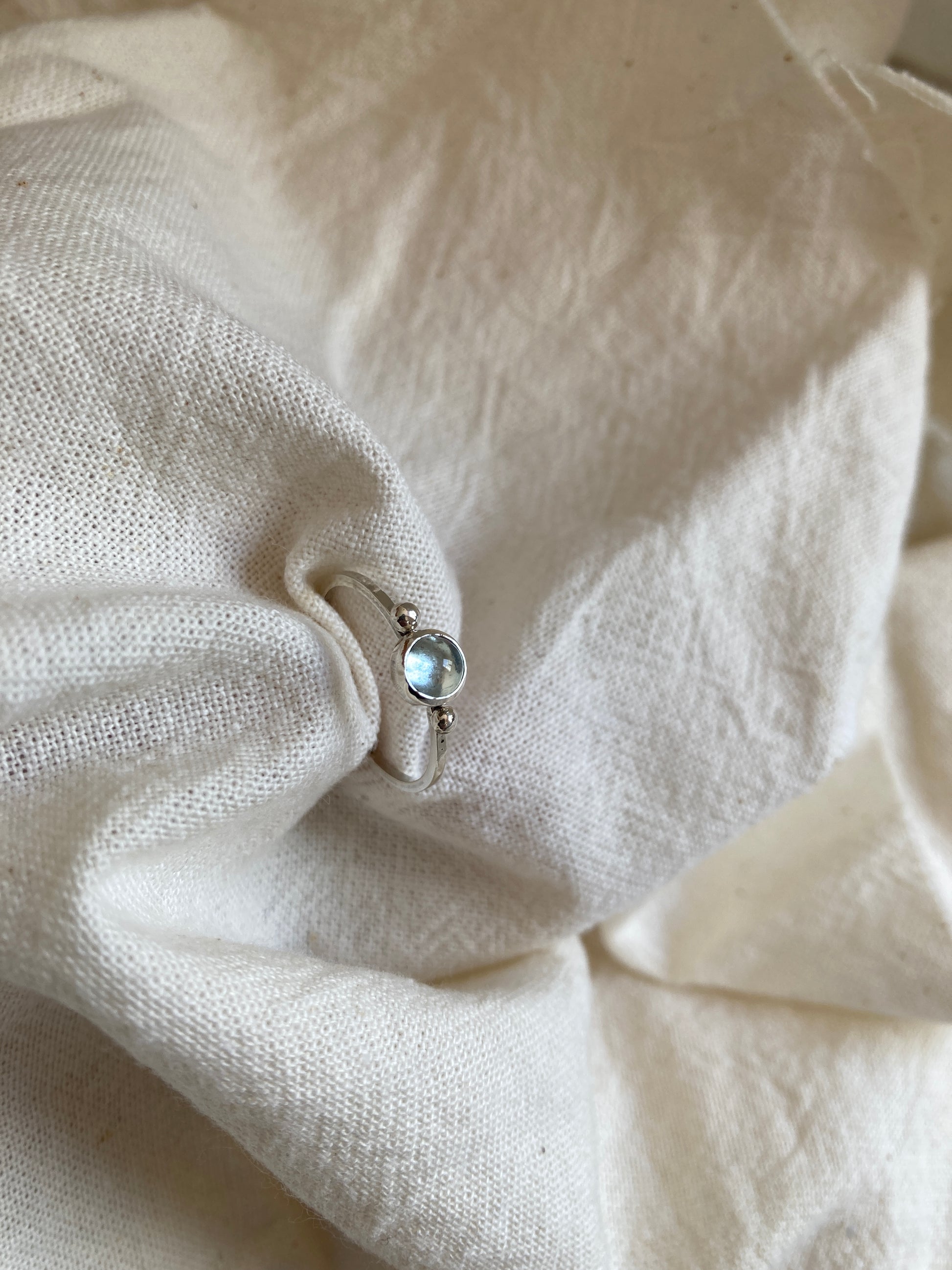 Sterling Silver Ring with two balls on either side of a Sky Blue Topaz Cabochon Stone