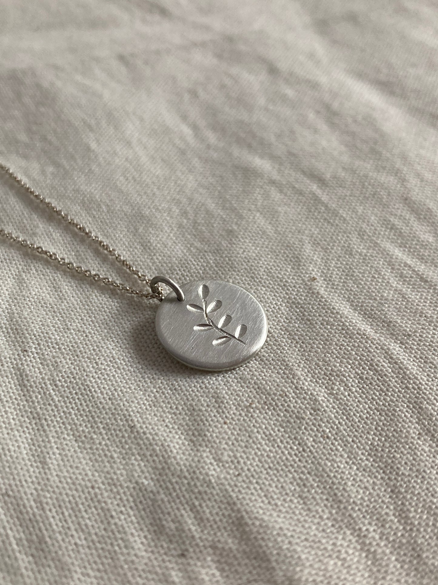 Sterling Silver Disc Pendant with engraved Leaves Design