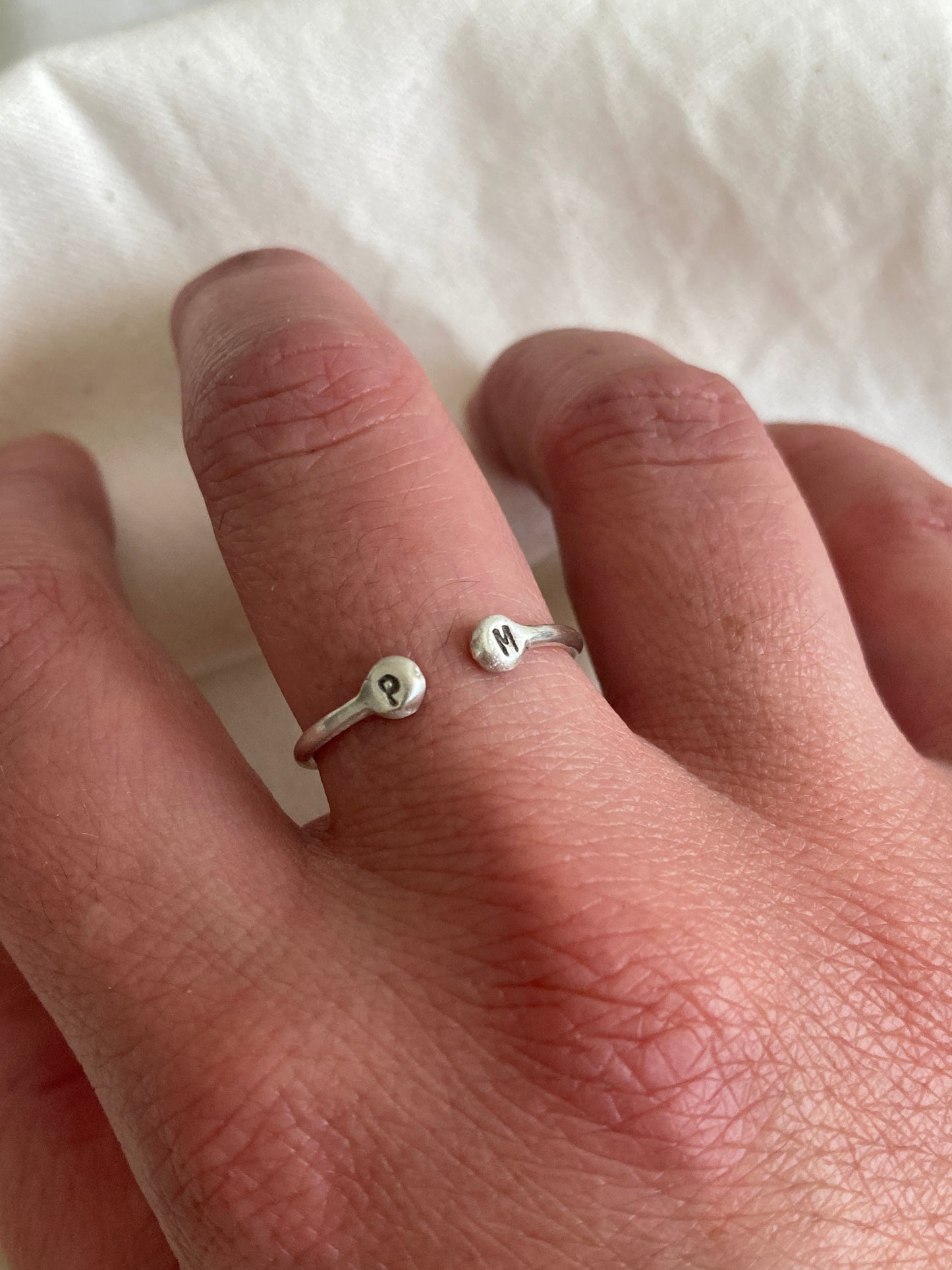 Sterling Silver Open Ring with pebble detail on the ends with hand stamped initials