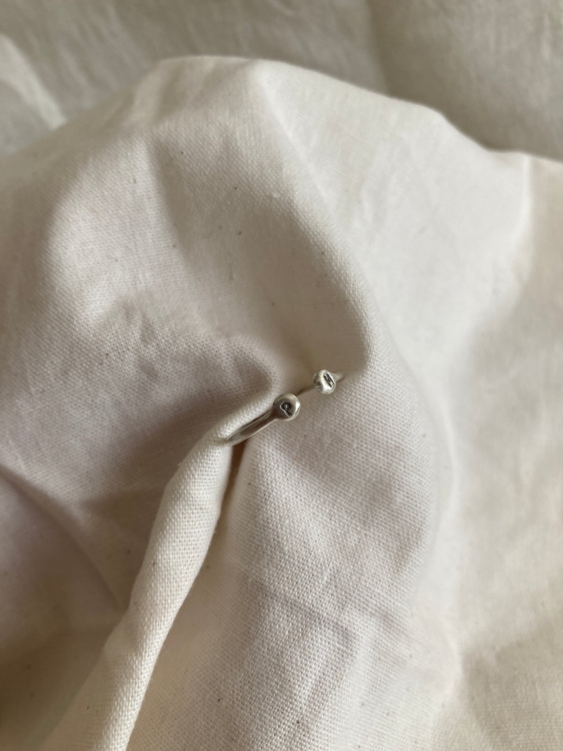 Sterling Silver Open Ring with pebble detail on the ends with hand stamped initials