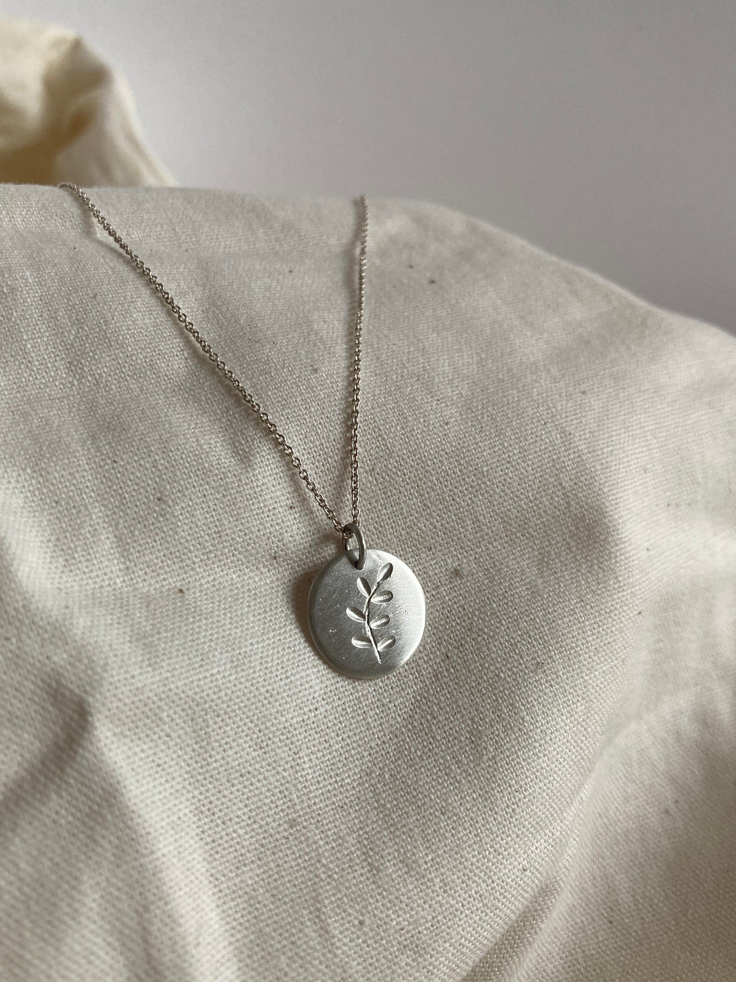 Sterling Silver Disc Pendant with engraved Leaves Design