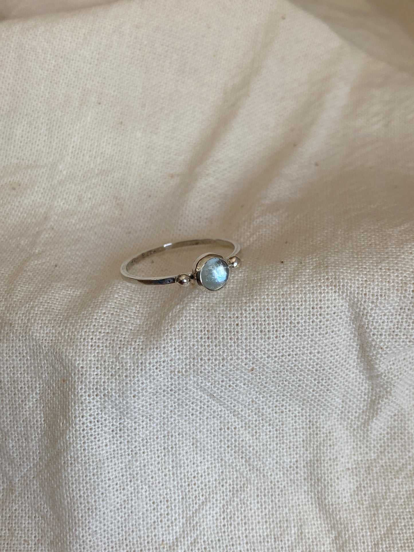 Sterling Silver Ring with two balls on either side of a Sky Blue Topaz Cabochon Stone