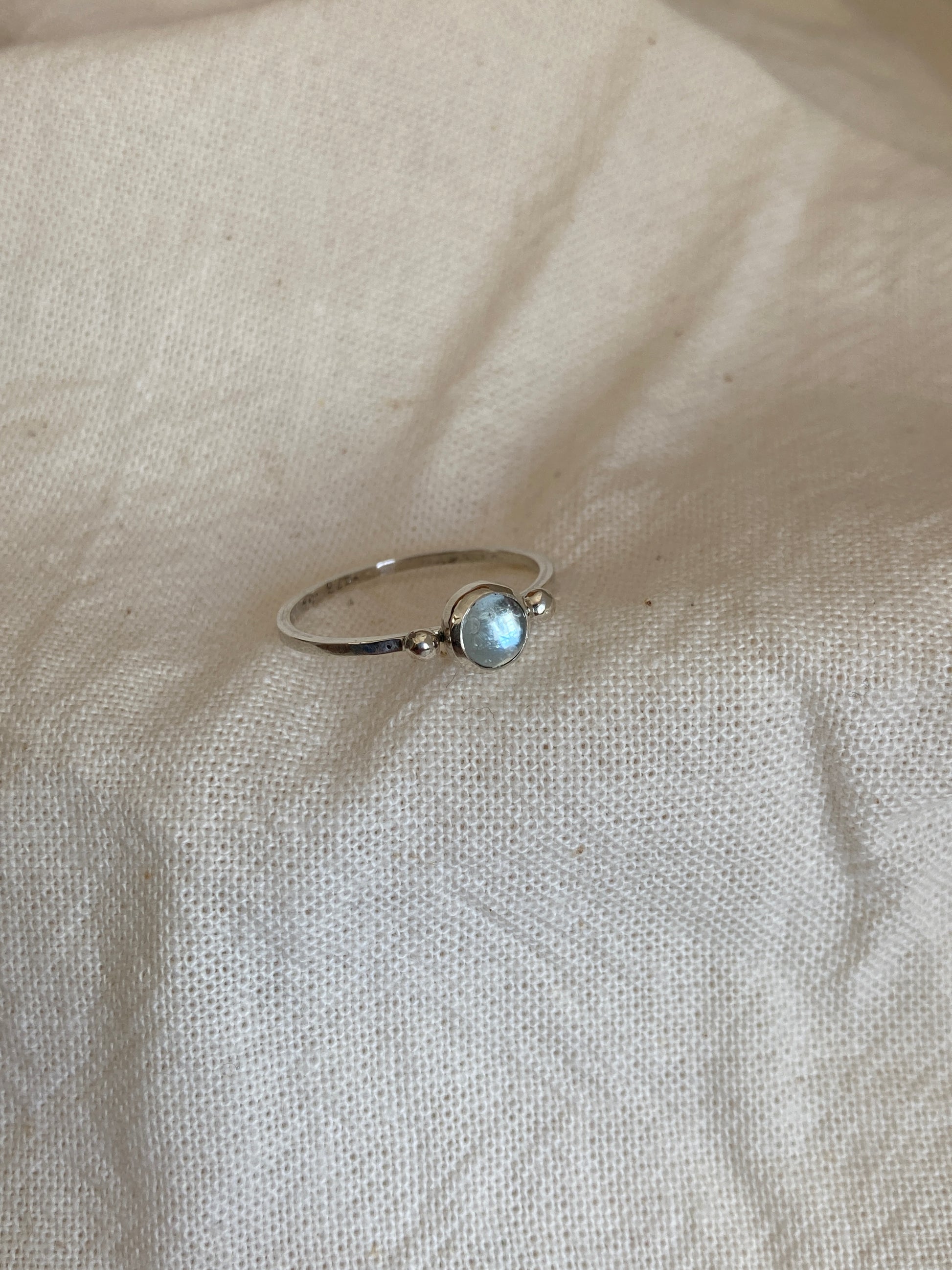 Sterling Silver Ring with two balls on either side of a Sky Blue Topaz Cabochon Stone