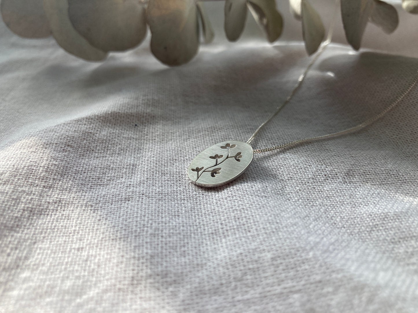 Sterling Silver Oval Pendant with Botanical cut-out inspired by flowers in Bloom on Silver Chain